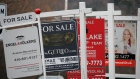 Real estate for sale signs are shown in Oakville, Ont. on December 1, 2018. 