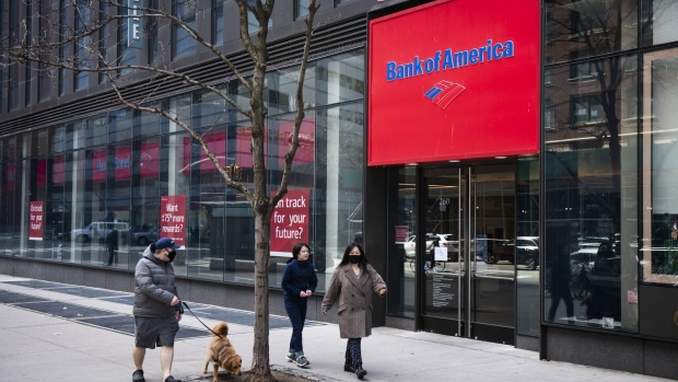 Pedestrians wearing protective masks pass a Bank of America Corp. branch in New York, U.S., on Saturday, April 11, 2020. Bank of America is scheduled to release earnings figures on April 15. Photographer: Mark Kauzlarich/Bloomberg
