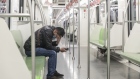 A passenger wearing a protective mask rides on a subway train in Shanghai, China, on Wednesday, Feb.