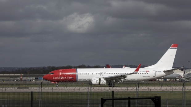 A passenger aircraft, operated by Norwegian Air Shuttle ASA, taxis along the runway at Gatwick Airport in Crawley, U.K., on Friday, Feb. 13, 2020. Norwegian Air is suspending thousands of flights and slashing its workforce in response to the fallout of the coronavirus and the widespread travel restrictions it’s triggered. Photographer: Chris Ratcliffe/Bloomberg