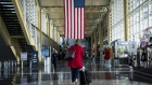 A traveler walks through Ronald Reagan National Airport (DCA) in Arlington, Virginia, U.S., on Monday, March 16, 2020.