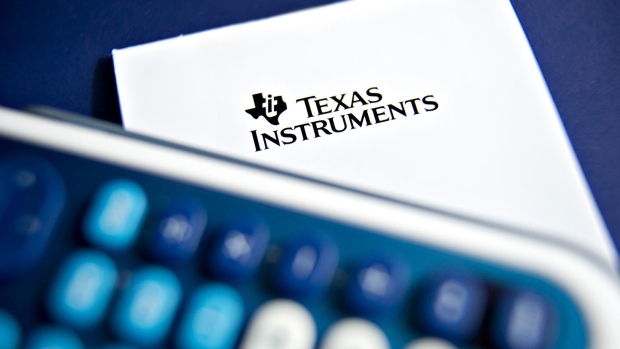 The Texas Instruments Inc. logo is arranged with a scientific calculator for a photograph in Tiskilwa, Illinois, U.S., on Sunday, April 17, 2011.