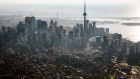 The CN Tower stands among buildings in the downtown skyline in this aerial photograph taken above Toronto, Ontario, Canada,
