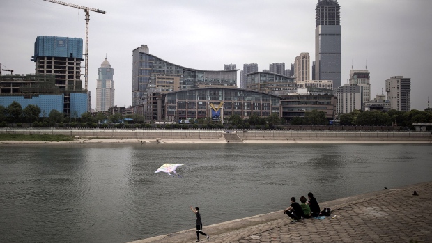 People sit by the Han river in Wuhan on April 17.