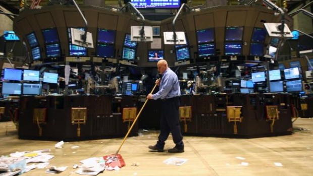 UNITED STATES - DECEMBER 31: An employee cleans up trash on the floor of the New York Stock Exchange after the close of the final trading session of 2008 in New York, U.S., on Wednesday, Dec. 31, 2008. U.S. stocks gained for a second day, trimming losses at the end of the market's worst year since the Great Depression, as fewer Americans filed for jobless benefits and the Treasury said it will expand aid to the car industry. (Photo by Daniel Acker/Bloomberg via Getty Images)