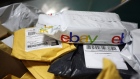 A parcel in eBay Inc. packaging is seen on a conveyor belt with other small parcels at the United States Postal Service.