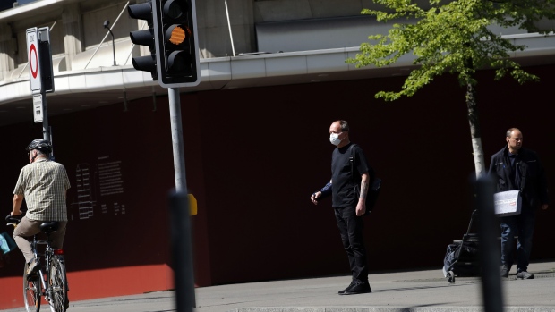 A pedestrian wearing a protective face mask walks along the Bahnhofstrasse in Zurich on April 17. Photographer: Stefan Wermuth/Bloomberg