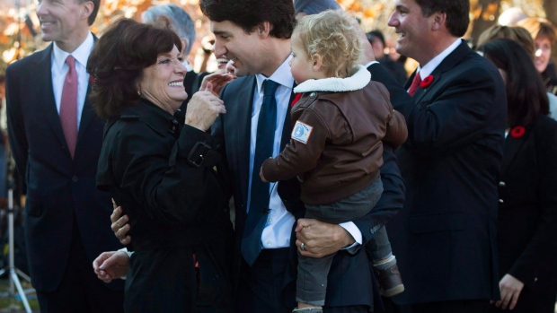 Justin Trudeau holds his son Hadrien while hugging his mother Margaret Trudeau outside Rideau Hall.