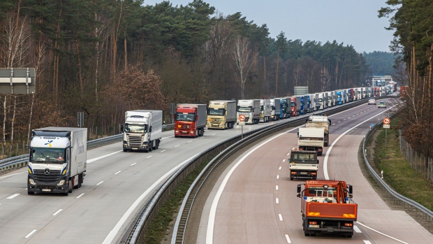 Haulage trucks travel eastwards in convoy on the Bundesautobahn A12 with their cargo during European Union (EU) citizen movement restrictions and coronavirus containment efforts on the border of Germany and Poland, in Frankfurt an der Oder, Germany, on Thursday, March 19, 2020. With much of Europe in lockdown not seen since World War II, responses to the spread of the Covid-19 outbreak are testing the most binding principle of the continent’s postwar integration project—the freedom of movement enshrined in the 27-nation European Union’s treaty. Photographer: Rolf Schulten/Bloomberg