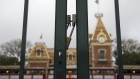 A locked gate stands at the main entrance of Walt Disney Co.'s Disneyland theme park in Anaheim on March 13. Photographer: Patrick T. Fallon/Bloomberg
