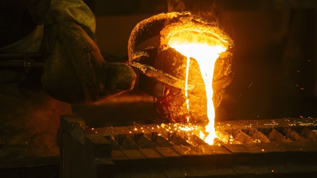 A worker pours molten gold into a mould during the refining of bullion at the Rand Refinery Ltd. plant in Germiston, South Africa, on Wednesday, Aug. 16. 2017. Established by the Chamber of Mines of South Africa in 1920, Rand Refinery is the largest integrated single-site precious metals refining and smelting complex in the world, according to their website. Photographer: Waldo Swiegers/Bloomberg
