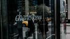 Pedestrians pass in front of a Charles Schwab Corp. office building in New York. Photographer: Christopher Lee/Bloomberg