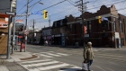 A pedestrian crosses a nearly empty street in Toronto, Ontario, Canada, on Wednesday, March 25, 2020.