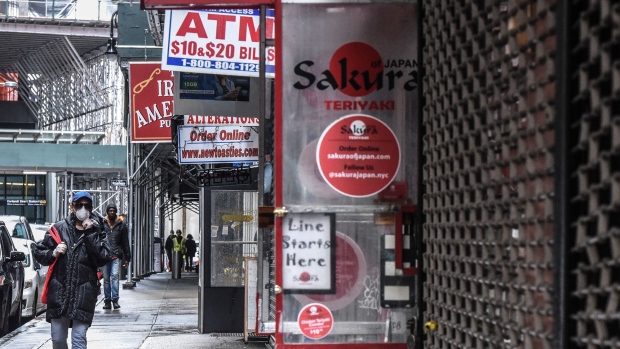 Pedestrians walk past closed businesses in New York City on April 30. 