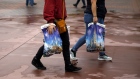 Guests carry shopping bags outside of Walt Disney Co.'s Disneyland theme park in Anaheim
