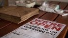 A "We're Open" sign sits on a table at a restaurant in Mobile, Alabama, U.S., on Friday, May 1, 2020
