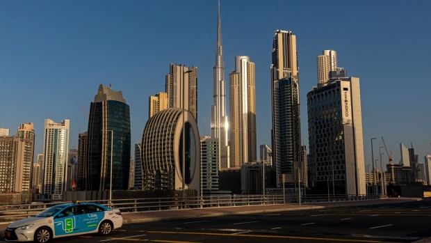 A taxi drives along an empty highway in Dubai. Photographer: Christopher Pike/Bloomberg