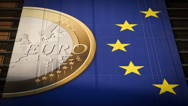 A giant euro banner, featuring an image of a euro coin and promoting stronger European economic governance, hangs on the side of the headquarters of the European Union commission at the Berlaymont Building, in Brussels, Belgium on Monday Nov. 21, 2011.