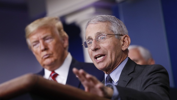 Anthony Fauci, director of the National Institute of Allergy and Infectious Diseases, speaks as U.S. President Donald Trump, left, listens during a Coronavirus Task Force news conference in the briefing room of the White House in Washington, D.C., U.S., on Friday, March 20, 2020. Americans will have to practice social distancing for at least several more weeks to mitigate U.S. cases of Covid-19, Anthony S. Fauci of the National Institutes of Health said today. Photographer: Al Drago/Bloomberg