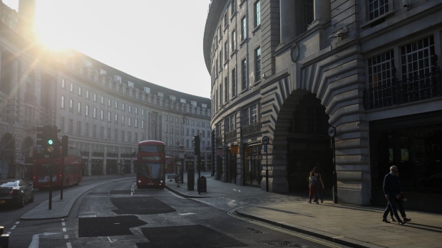 Buses travel past closed shops on Regent Street in central London. Photographer: Simon Dawson/Bloomberg
