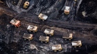 Heavy haulers are seen at the Suncor Energy Inc. Fort Hills mine in this aerial photograph taken above the Athabasca oil sands near Fort McMurray, Alberta, Canada, on Monday, Sept. 10, 2018. While the upfront spending on a mine tends to be costlier than developing more common oil-sands wells, their decades-long lifespans can make them lucrative in the future for companies willing to wait. Photographer: Ben Nelms/Bloomberg