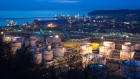Oil storage tanks stand illuminated at night at the RN-Tuapsinsky refinery, operated by Rosneft Oil 