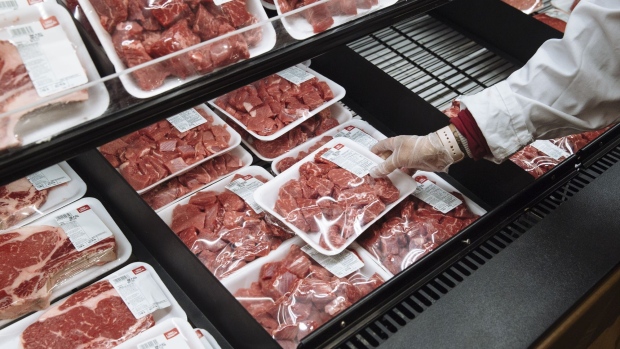 A worker restocks beef at a Stew Leonard's supermarket in Paramus, New Jersey, U.S., on Tuesday, May 12, 2020. Stew Leonard Jr. said that meat packing plant the company uses is operating at about 70 percent capacity, and he expects it to rebound to full capacity in about a month, CT Post reported. Photographer: Angus Mordant/Bloomberg