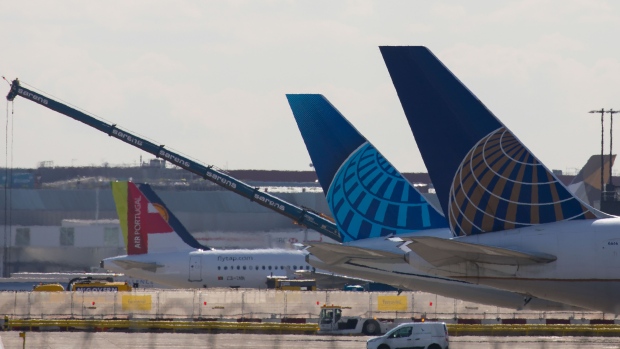 The tail fins of a passenger aircraft, operated by United Airlines Holdings Inc., sit on the tarmac tail-fins sit at London Heathrow Airport in London, U.K. on Monday, March 16, 2020.