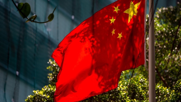The Chinese flag flies outside the Liaison Office of the Central People's Government in the Sai Ying Pun district of Hong Kong, China, on Monday, April 20, 2020. China is again taking steps to rein in Hong Kong's democracy advocates, drawing fresh condemnation from the U.S. while also antagonizing protesters who paralyzed the city for much of last year. Photographer: Paul Yeung/Bloomberg