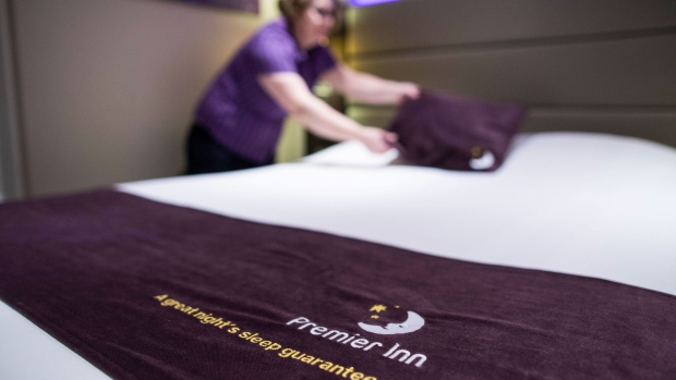 A chambermaid makes a bed in a bedroom at a Premier Inn hotel, operated by Whitbread Plc, in London, U.K., on Wednesday, Jan. 17, 2018. The hotel and restaurant group, that owns Premier Inn hotels and Costa Coffee, is due to report third quarter results on Thursday. Photographer: Chris Ratcliffe/Bloomberg