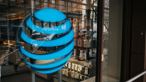 The AT&T Inc. logo is displayed outside a store in New York, U.S., on Wednesday, June 13, 2018. Photographer: Christopher Lee/Bloomberg