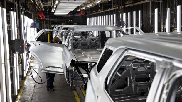 An employee inspects a vehicle frame at the Ford Motor Co. Chicago Assembly Plant in Chicago, Illinois, U.S