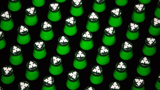 A logo sits on the top caps of green bottles of Carlsberg beer as they move along the production line following the labeling process at the Baltika Breweries LLC plant, operated by Carlsberg A/S, in Saint Petersburg, Russia, on Thursday, May 10, 2018. A slowdown in Russian demand for beer as international sanctions threaten the country's economy is weighing on Danish brewer Carlsberg's sales. Photographer: Andrey Rudakov/Bloomberg
