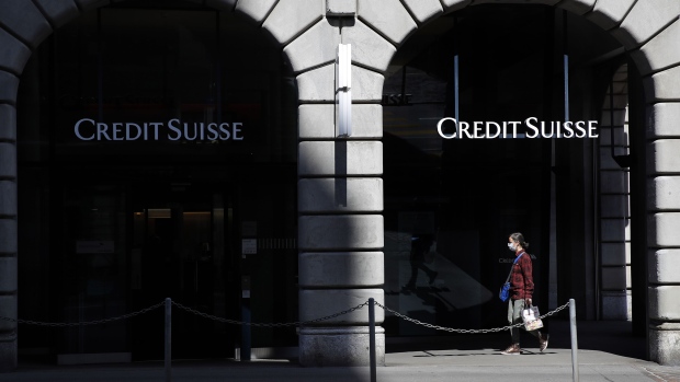 A pedestrian wearing a protective face mask walks past a Credit Suisse Group AG bank branch in Zurich, Switzerland, on Friday, April 17, 2020. Credit Suisse compensated managers and employees with additional shares in the bank after the price dropped sharply during the depths of a market correction spurred by the coronavirus outbreak. Photographer: Stefan Wermuth/Bloomberg