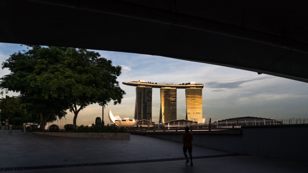 The Marina Bay Sands hotel and casino stands at dusk during the "circuit breaker" lockdown in Singapore, on Wednesday, May 20, 2020. Singapore will allow more businesses to reopen on June 2 -- increasing the active proportion of the economy to three-quarters -- after a nationwide lockdown cut transmission of the coronavirus among citizens and permanent residents. Photographer: Lauryn Ishak/Bloomberg