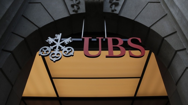 A sign hangs above the entrance to the UBS Group AG headquarters in Zurich, Switzerland. Photographer: Stefan Wermuth/Bloomberg