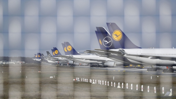 Passenger aircraft, operated by Deutsche Lufthansa AG, sit grounded on the closed north west runway at Frankfurt Airport, operated by Fraport AG, in Frankfurt, Germany, on Wednesday, March 25, 2020. Unable to fill planes with passengers as the coronavirus destroys travel demand, airlines are instead using their fleets to transport more cargo, including medicines, smartphones and Korean strawberries. Photographer: Alex Kraus/Bloomberg