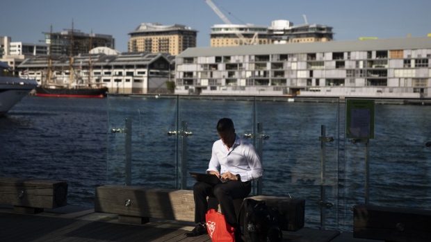 A man types on a laptop computer while sitting by Darling Harbour in Sydney, Australia, on Monday, Nov. 11, 2019. Australia is bracing for more devastating bushfires, with swaths of the eastern seaboard and even areas of greater Sydney facing a "catastrophic" threat that's unprecedented at this time of year. Photographer: Brent Lewin/Bloomberg