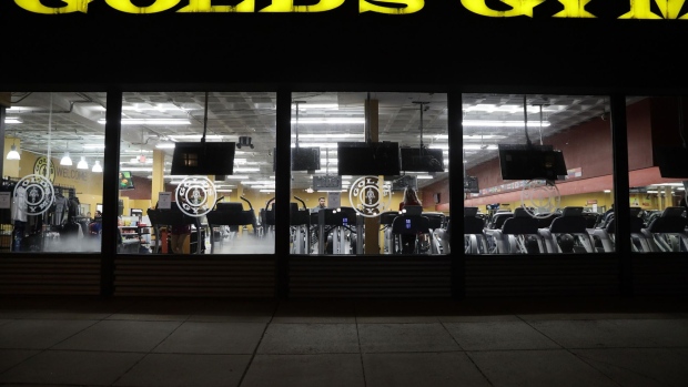 People work out at a Gold’s Gym on March 16.