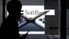 The SoftBank Corp. logo is displayed alongside notices indicating a change in closing time and for wearing protective masks when visiting a store on a glass door of a store in Tokyo, Japan, on Tuesday, April 14, 2020. SoftBank Group forecast a record 1.35 trillion yen ($12.5 billion) operating loss for the fiscal year ended in March, a sign of how badly Masayoshi Son's bets on technology startups have been battered in recent months. Photographer: Kiyoshi Ota/Bloomberg