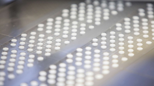 Euthyrox hypothyroid treatment tablets pass through a blister pack packaging machine inside Merck KGaA's pharmaceutical laboratories at the company's headquarters in Darmstadt, Germany, on Thursday, Nov. 3, 2016. Merck and Idemitsu Kosan Co Ltd. today signed an agreement to allow each party to use the other's organic light-emitting diode (OLED) material-related patents in certain areas. Photographer: Martin Leissl/Bloomberg