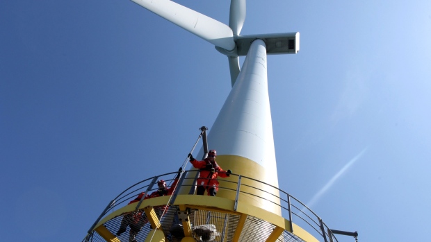 A technician raises maintenance equipment on to a wind turbine at a facility near Great Yarmouth, U.K. Photographer: Chris Ratcliffe/Bloomberg