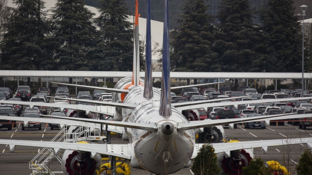 Grounded Boeing Co. 737 Max airplanes are seen in a parking lot near Boeing Field in Seattle, Washington, U.S., on Tuesday, Dec. 17, 2019. Boeing plans to halt production of its grounded 737 Max in January, a move that will deepen the crisis engulfing the planemaker, complicate its eventual recovery and ripple through the U.S. economy. Photographer: David Ryder/Bloomberg