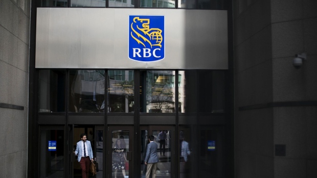 People enter and exit from the Royal Bank of Canada (RBC) headquarters in the financial district of Toronto, Ontario, Canada, on Thursday, July 25, 2019. Canadian stocks fell as tech heavyweight Shopify Inc. weighed on the benchmark and investors continued to flee pot companies. Photographer: Brent Lewin/Bloomberg