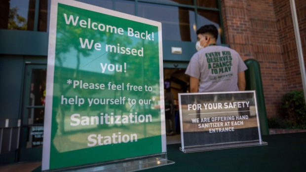 GLENDALE, CA - MAY 27: Masks and hand sanitizer are given to customers entering a Dick's Sporting Goods store as Los Angeles County retail businesses reopen as the COVID-19 pandemic continues on May 27, 2020 in Glendale, Californias latest guidelines and allow the resumption of in-store shopping at low-risk retail stores, faith-based services, drive-in theaters and other recreational activities with reduced capacities and social distancing restrictions, starting today. Not reopening yet are personal services locations like hair salons and dining in at restaurants. (Photo by David McNew/Getty Images)