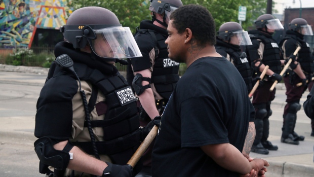 A protester goes face-to-face with a Minnesota state trooper