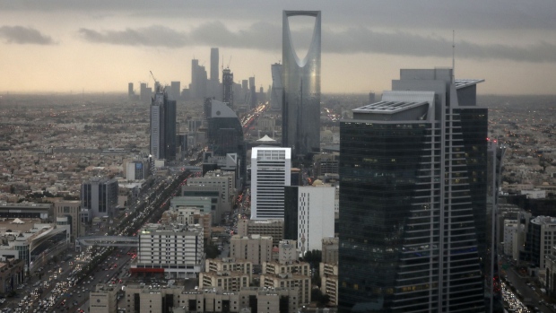 The Kingdom Tower, operated by Kingdom Holding Co., centre, stands on the skyline above the King Fahd highway in Riyadh, Saudi Arabia, on Monday, Nov. 28, 2016. Saudi Arabia and the emirate of Abu Dhabi plan to more than double their production of petrochemicals to cash in on growing demand. Photographer: Simon Dawson/Bloomberg