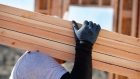 A worker carries lumber during the construction of a home in Lindon