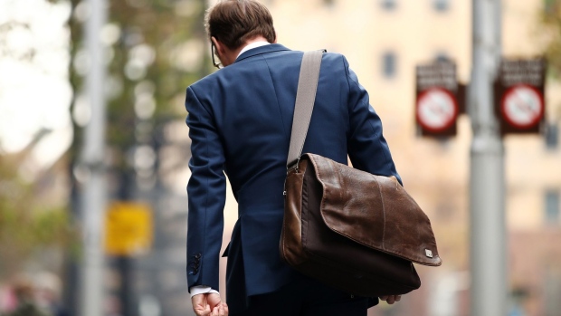 A commuter walks through the central business district of Sydney, Australia, on Monday, May 20, 2019. Prime Minister Scott Morrison's center-right government will command a parliamentary majority, the Australian Broadcasting Corp. projected Monday, fueling a stock market rally as investors welcomed his surprise victory in the weekend election. Prime Minister Scott Morrison's center-right government will command a parliamentary majority, the Australian Broadcasting Corp. projected Monday, fueling a stock market rally as investors welcomed his surprise victory in the weekend election. Photographer: Brendon Thorne/Bloomberg