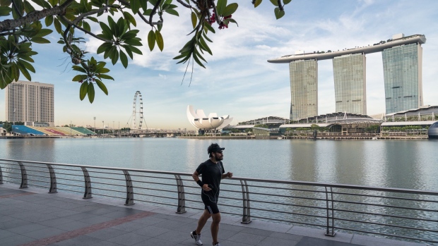 A jogger runs in a near-empty Merlion Park during the "circuit breaker" lockdown in Singapore, on May 20. Photographer: Lauryn Ishak/Bloomberg